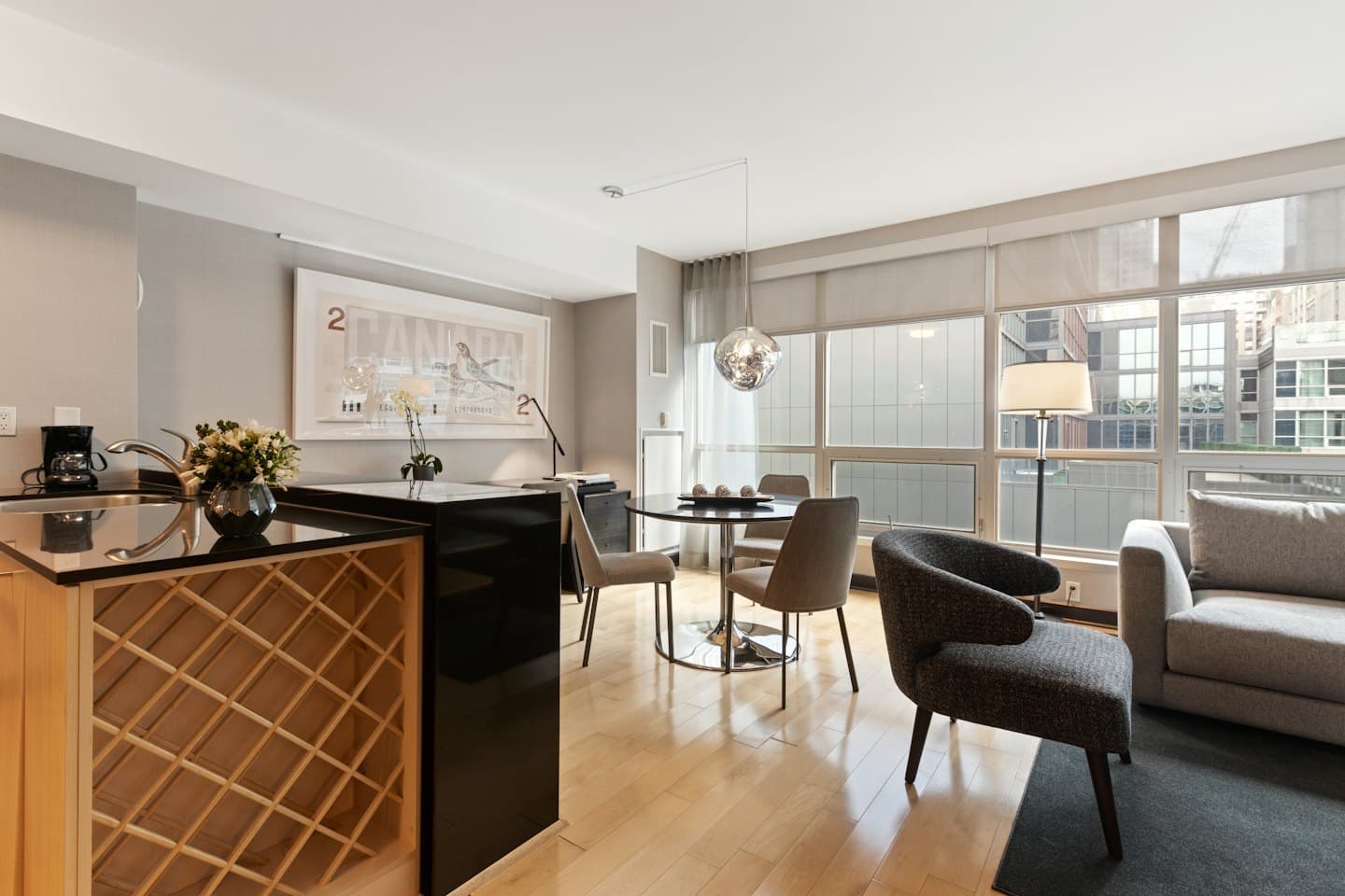 Modern apartment kitchen, dining, and living area.