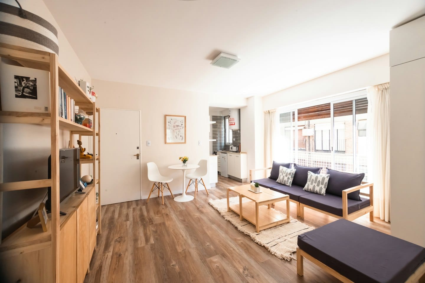 Modern apartment interior with living area and dining nook.